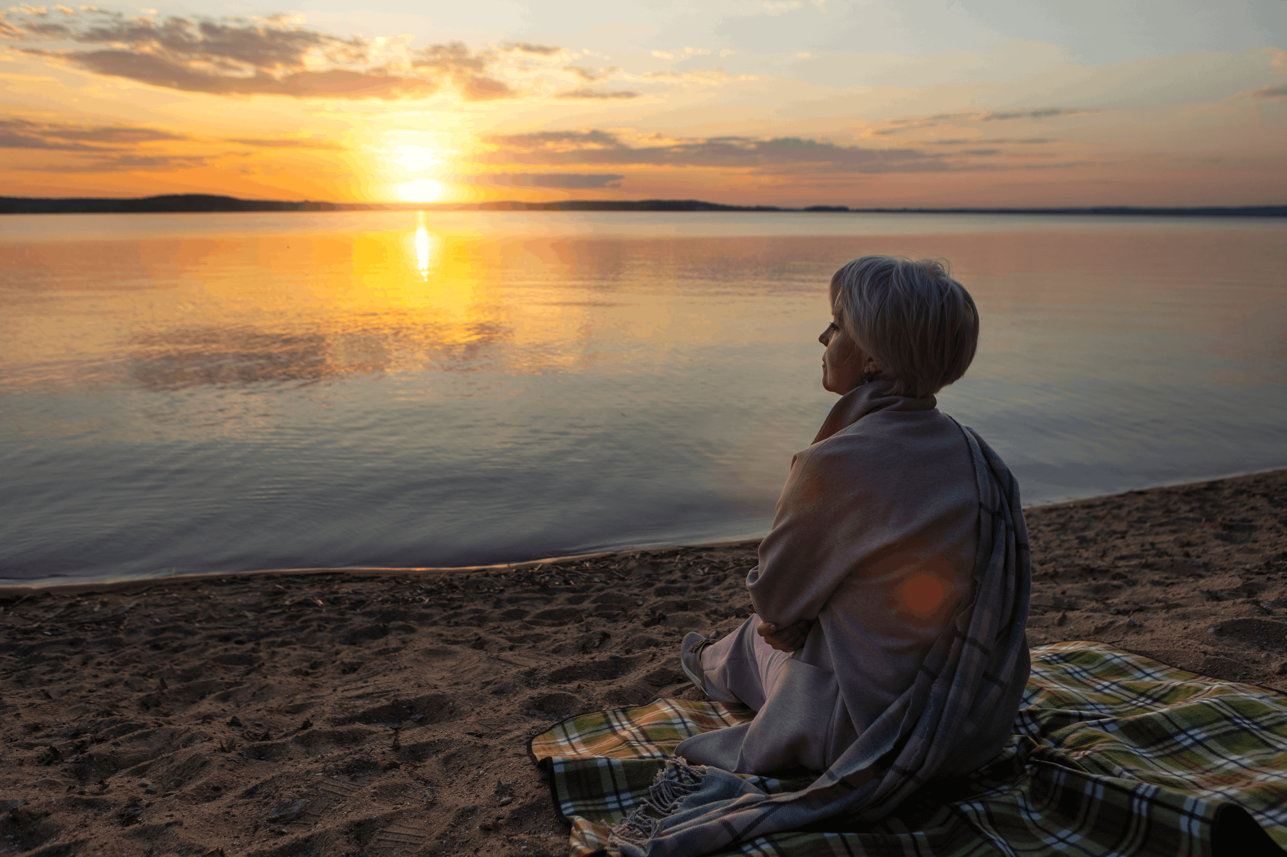 Person at sunset by water